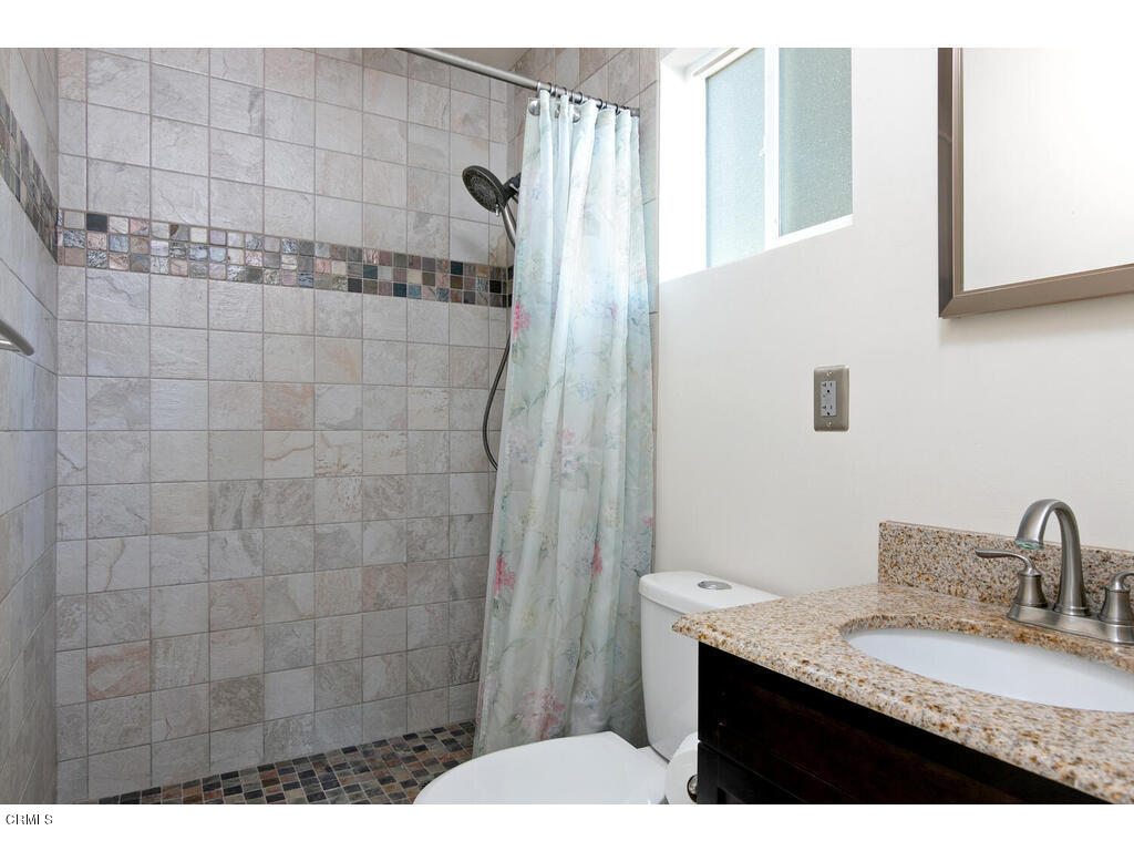 564 Burnham Road Oak View, CA 93022 - Photo 24 of 37 a bathroom with a granite countertop sink a mirror and shower