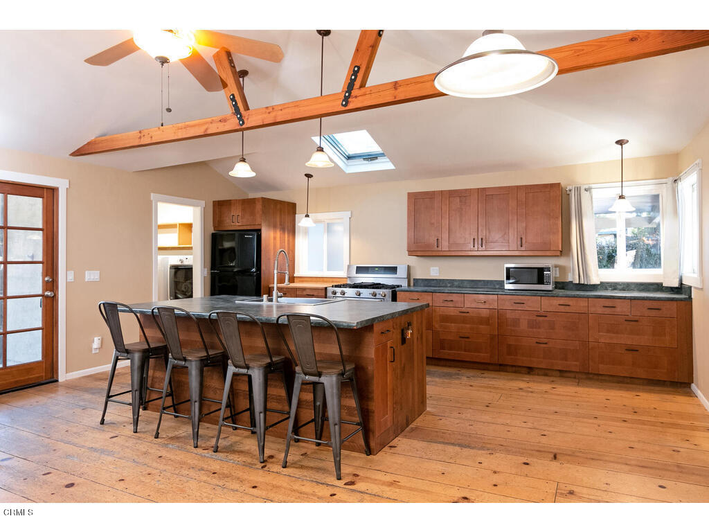 564 Burnham Road Oak View, CA 93022 - Photo 6 of 37 a large kitchen with a table and chairs