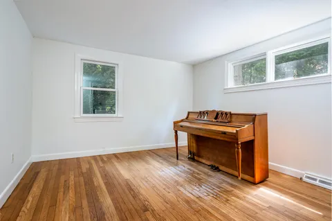 a view of a room with wooden floor and cabinet