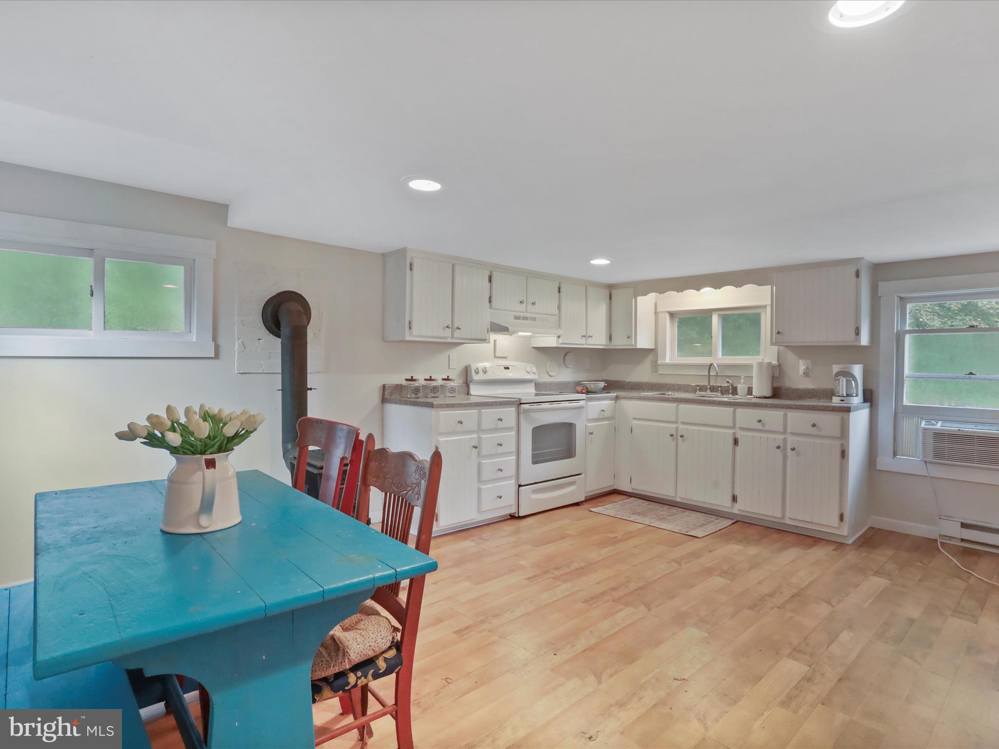 1485 Compton Hollow Road Rileyville, VA 22650 - Photo 17 of 55 a kitchen with a table chairs a sink dishwasher refrigerator and cabinets