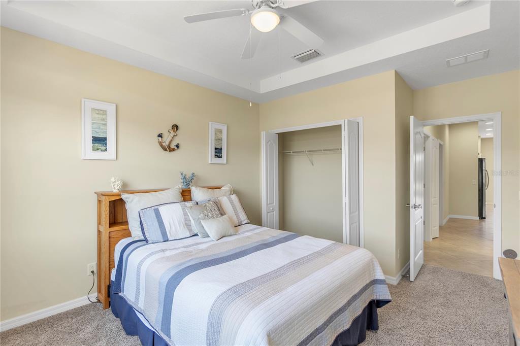 8141 Miramar Way, Unit 8141 Lakewood Ranch, FL 34202 - Photo 16 of 26 a bedroom with a bed and a painting on the wall