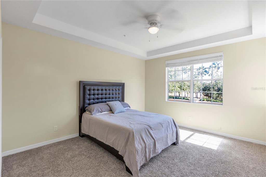 8141 Miramar Way, Unit 8141 Lakewood Ranch, FL 34202 - Photo 17 of 26 a spacious bedroom with a bed and a window