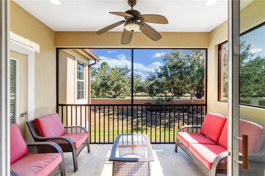 8141 Miramar Way, Unit 8141 Lakewood Ranch, FL 34202 - Photo 20 of 26 a living room with furniture and a floor to ceiling window