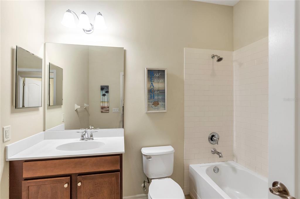 8141 Miramar Way, Unit 8141 Lakewood Ranch, FL 34202 - Photo 22 of 26 a bathroom with a sink a toilet and shower