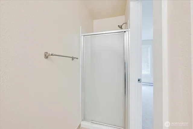 a bathroom with a glass shower door
