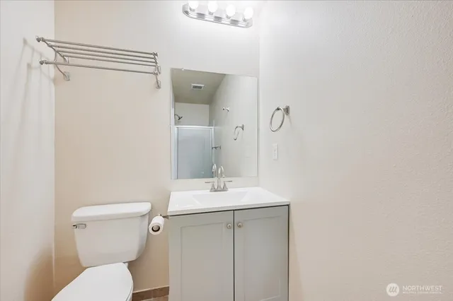 a bathroom with a toilet a sink and a mirror