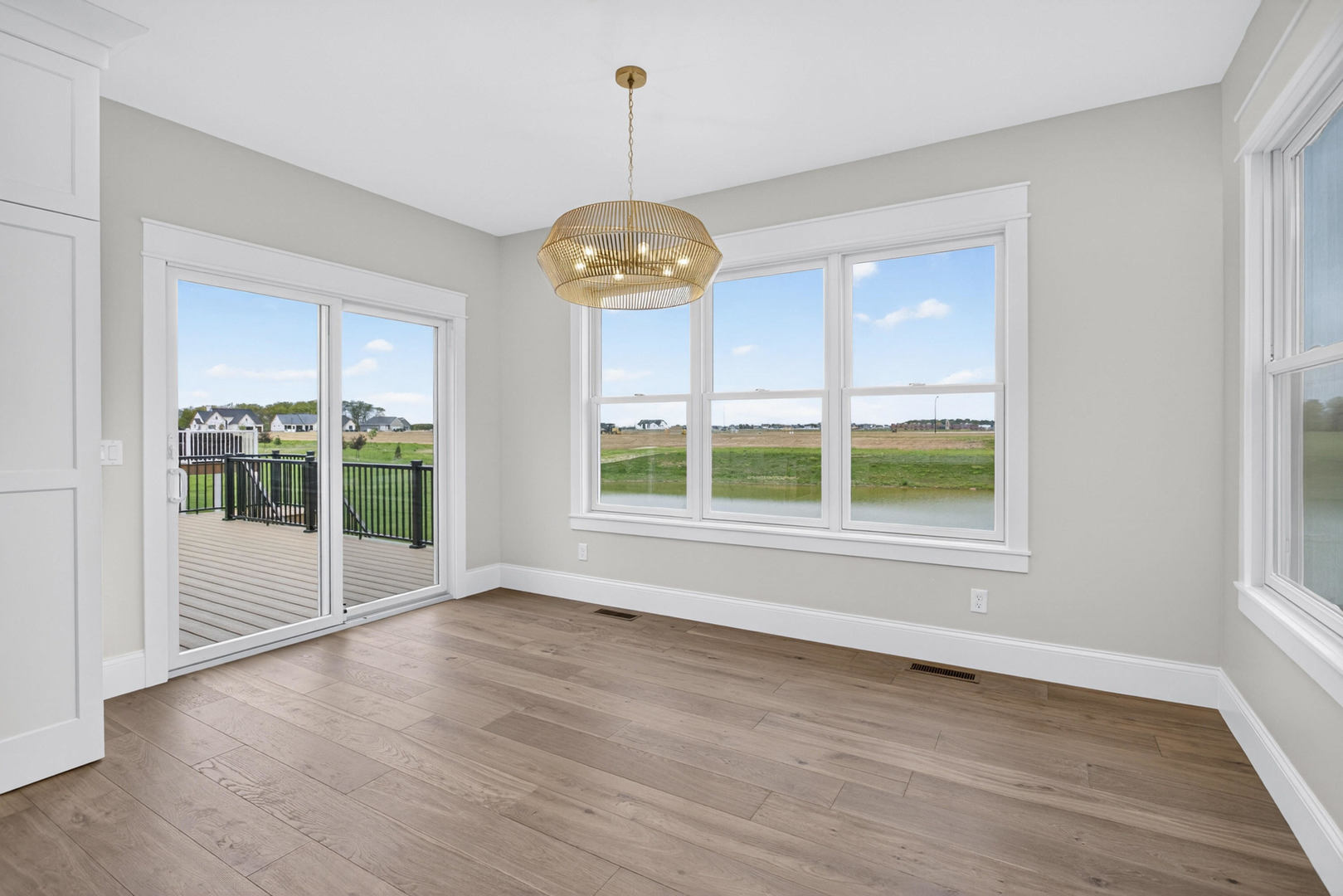 6928 Wilderness Pointe Bettendorf, IA 52722 - Photo 24 of 48 a view of an empty room with wooden floor and a window