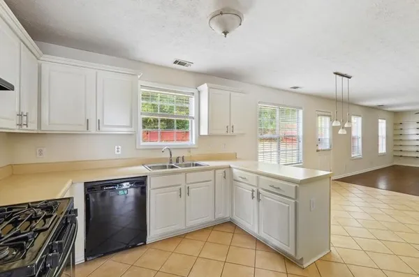 a kitchen with a sink stove and cabinets