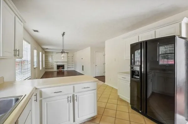a kitchen with a refrigerator a sink and cabinets