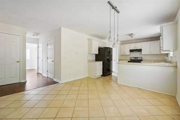 a kitchen with stainless steel appliances a refrigerator and a stove top oven