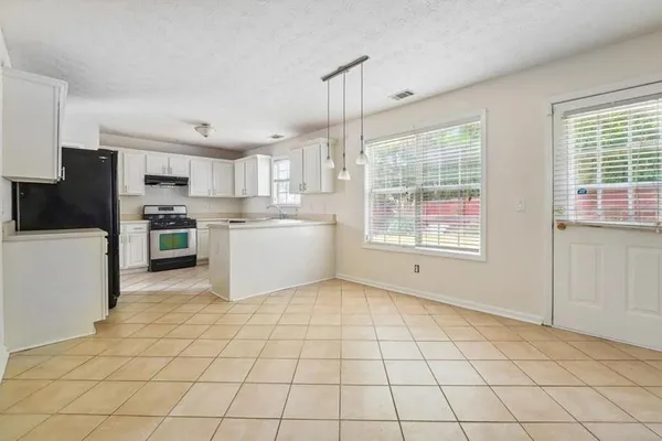 a kitchen with a stove a sink dishwasher and a refrigerator