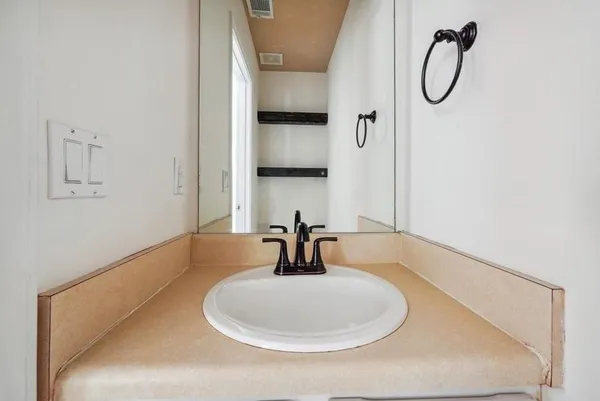 a bathroom with a sink and a mirror