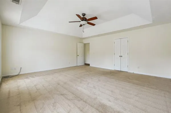 a view of a livingroom with a ceiling fan & window
