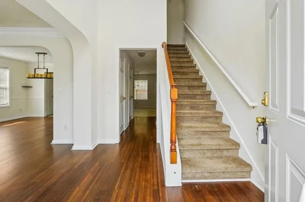 a view of a hallway view with wooden floor and staircase