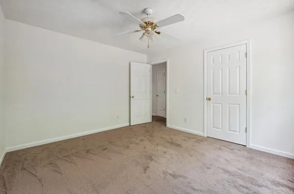 a view of an empty room with a ceiling fan