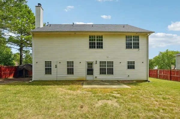 a view of a house with a backyard
