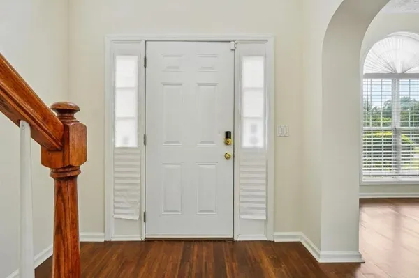a view of hallway with wooden floor and stairs