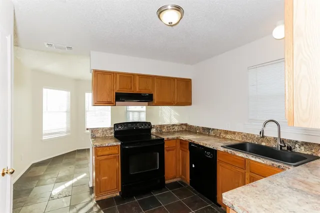 a kitchen with a sink stove and cabinets