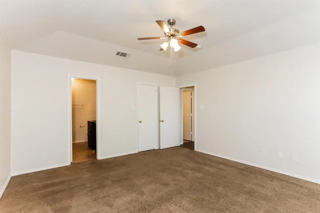 a view of a livingroom with a ceiling fan and window