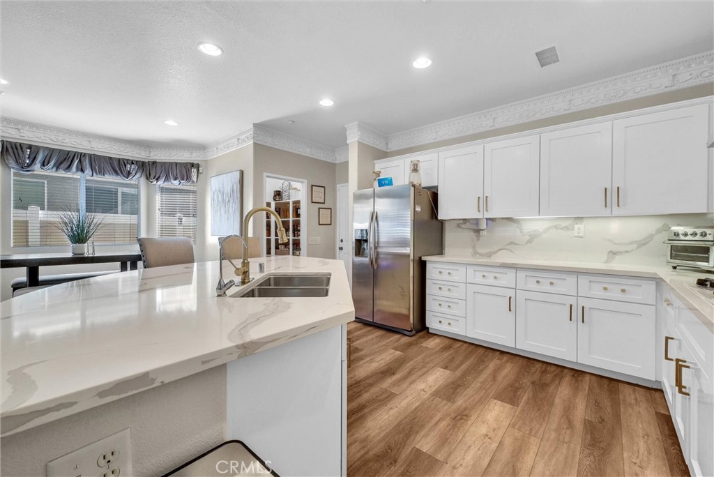 11499 Bridgeway Drive Riverside, CA 92505 - Photo 14 of 70 a kitchen with stainless steel appliances granite countertop a sink dishwasher stove and refrigerator