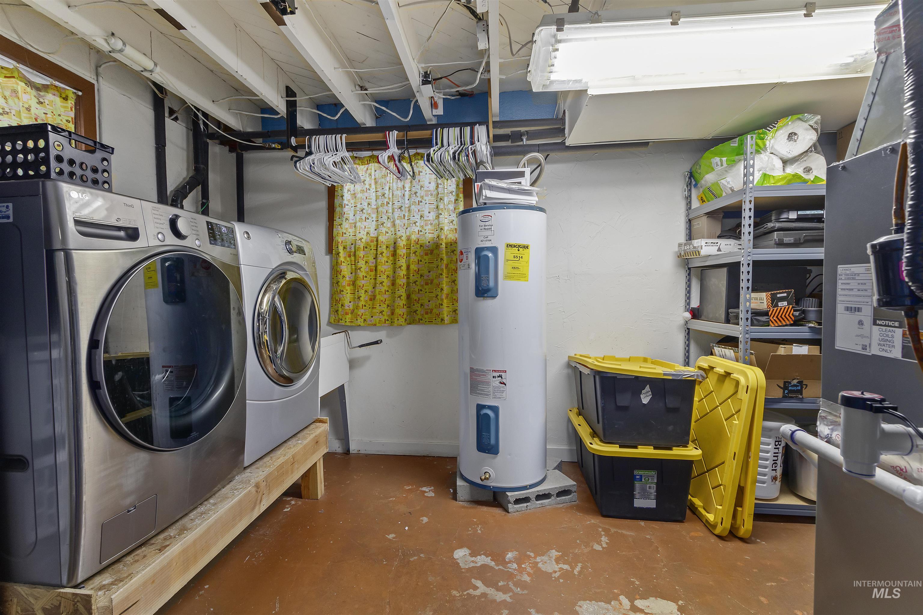 184 Taylor Street Twin Falls, ID 83301 - Photo 15 of 23 Laundry area featuring concrete floors, electric water heater, washing machine and clothes dryer, and heating unit