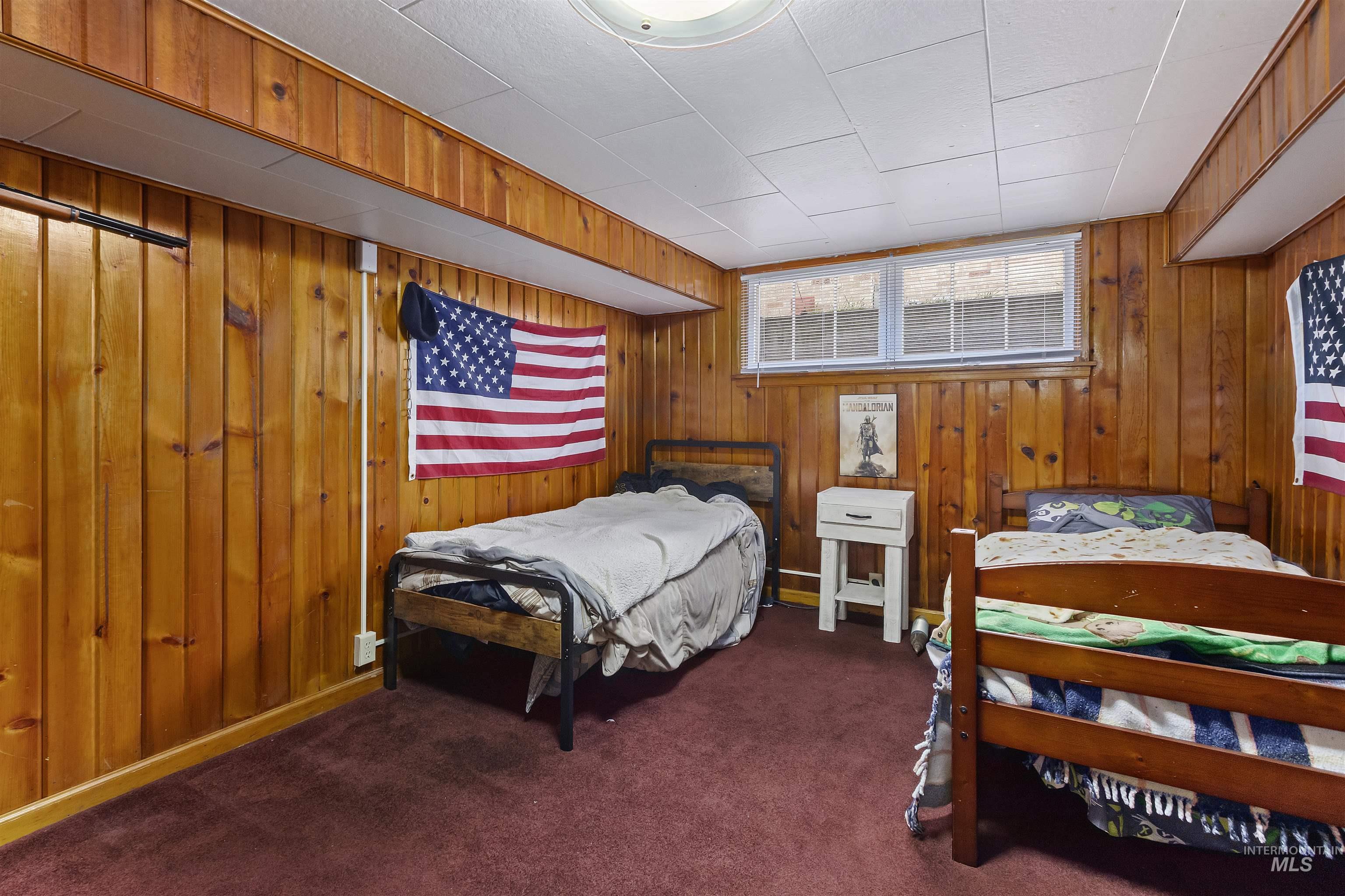 184 Taylor Street Twin Falls, ID 83301 - Photo 16 of 23 Carpeted bedroom with wooden walls
