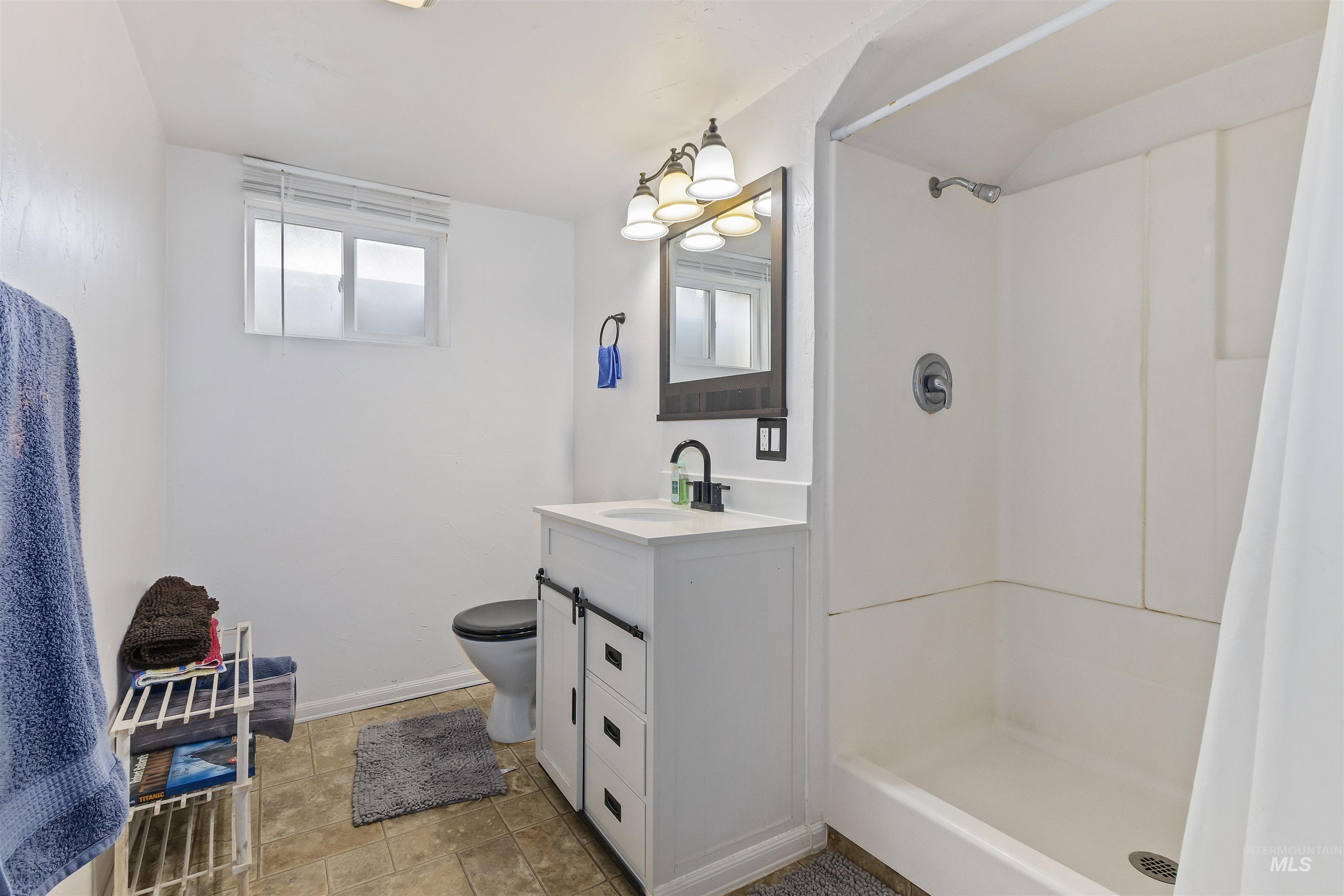 184 Taylor Street Twin Falls, ID 83301 - Photo 18 of 23 Full bathroom featuring vanity and a shower stall