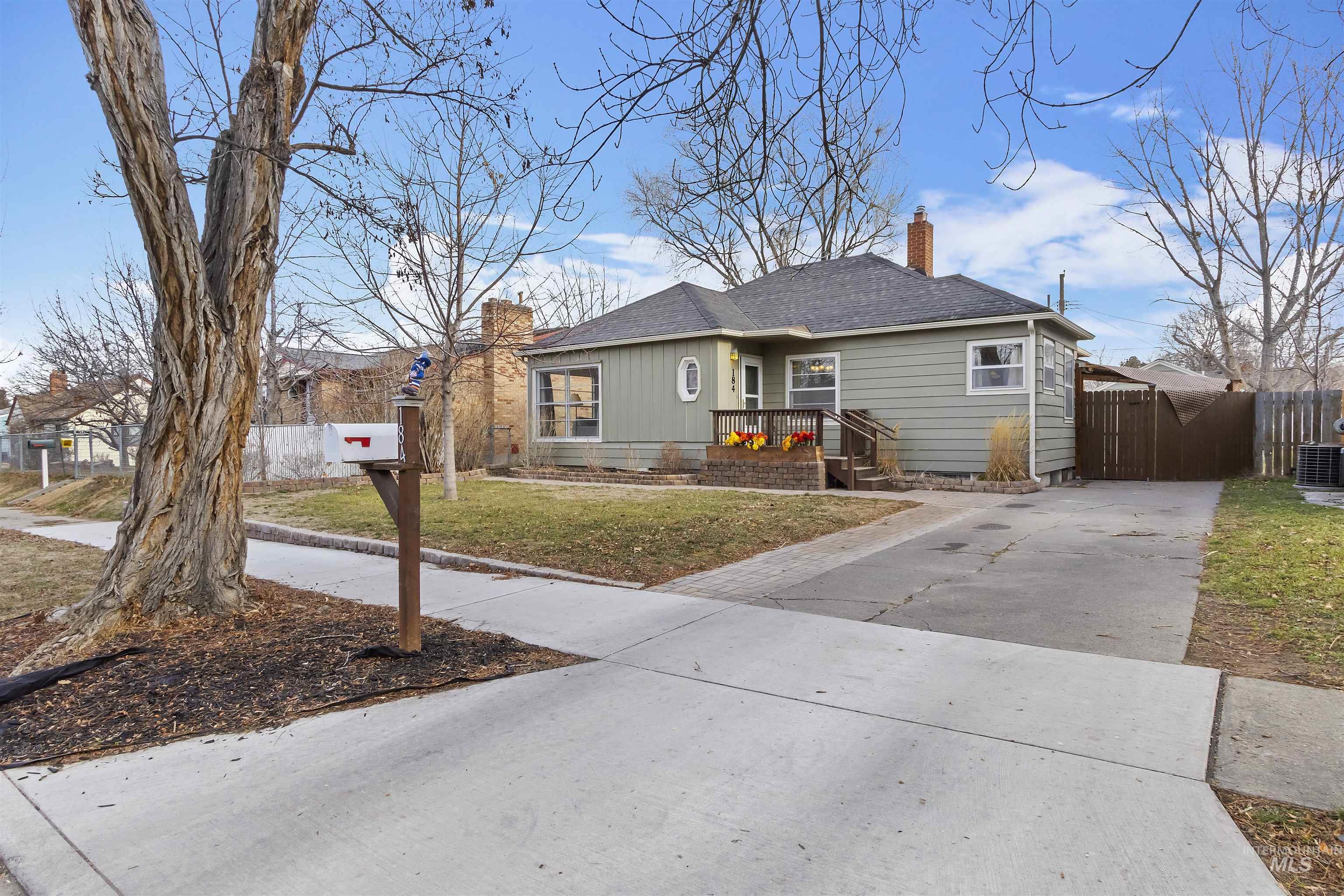184 Taylor Street Twin Falls, ID 83301 - Photo 2 of 23 View of front facade with concrete driveway, a chimney, roof with shingles, and a gate