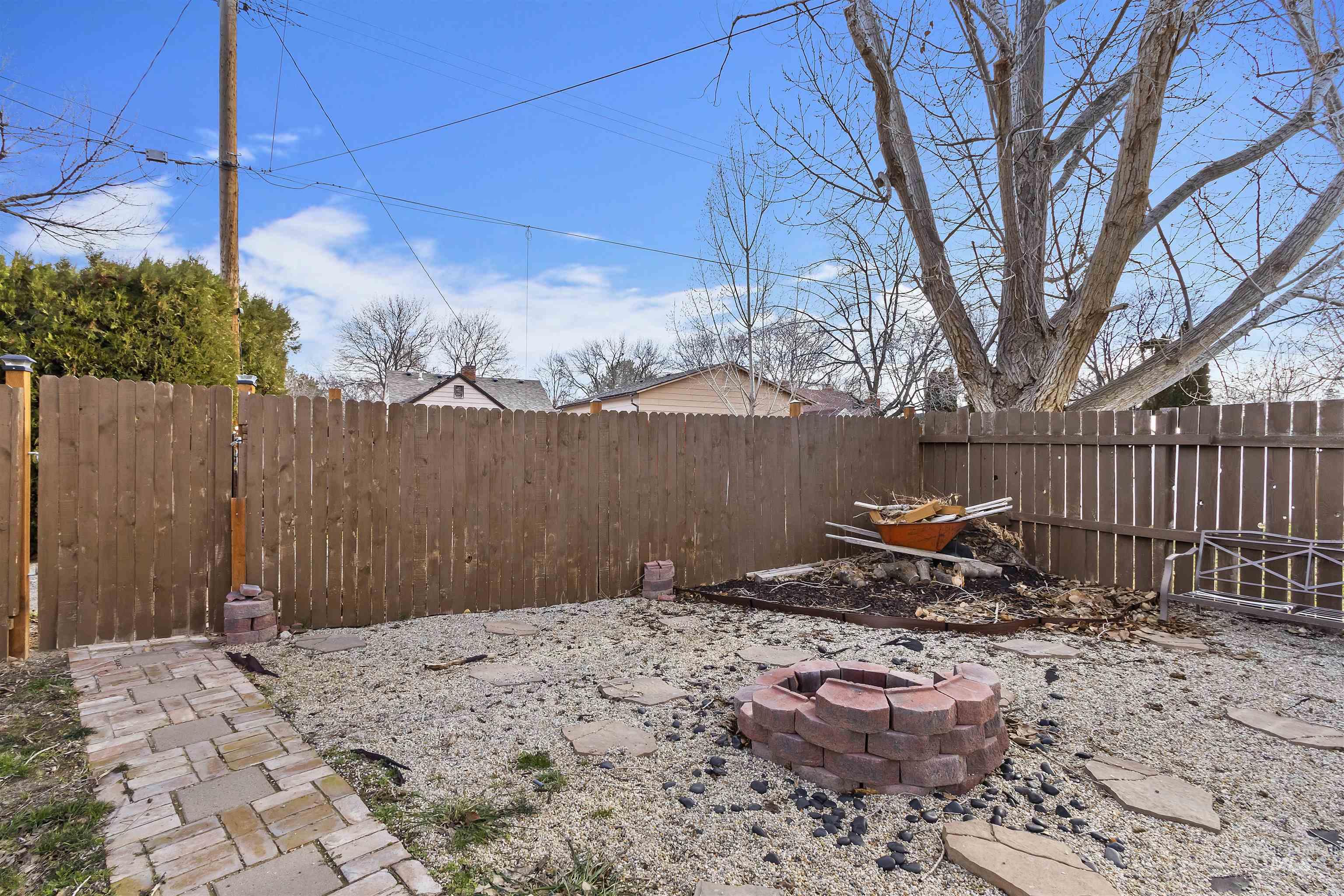 184 Taylor Street Twin Falls, ID 83301 - Photo 21 of 23 Fenced backyard with an outdoor fire pit