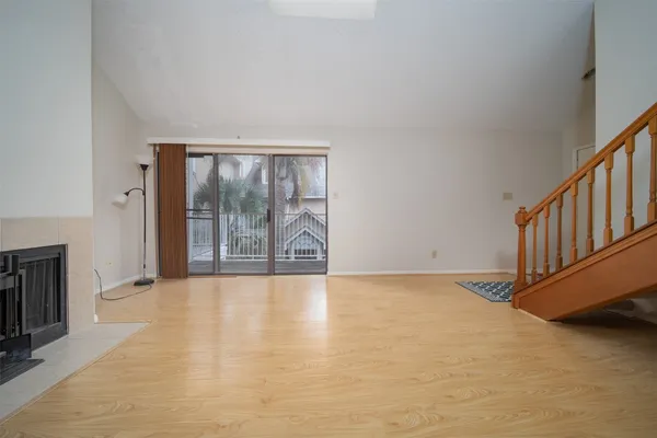 a view of an empty room with glass door