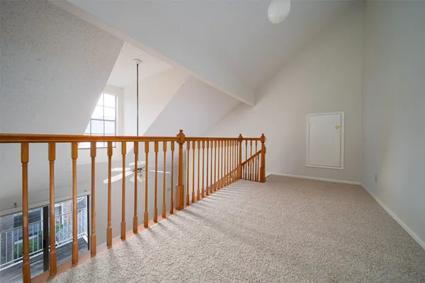 a view of a hallway with stairs