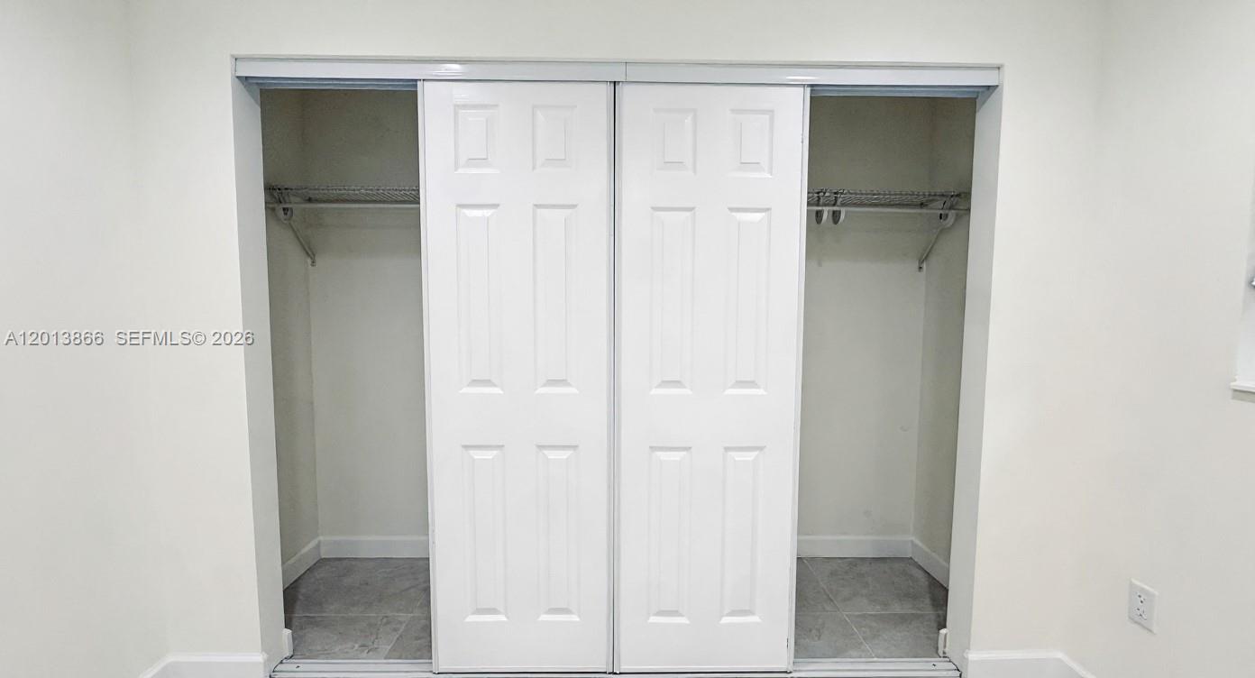 8440 Southwest 107th Street, Unit GH Miami, FL 33156 - Photo 17 of 22 a view of a bathroom with a glass door