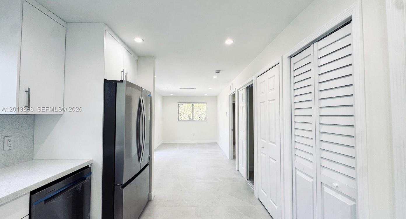 8440 Southwest 107th Street, Unit GH Miami, FL 33156 - Photo 2 of 22 a view of a kitchen with a refrigerator and cabinets