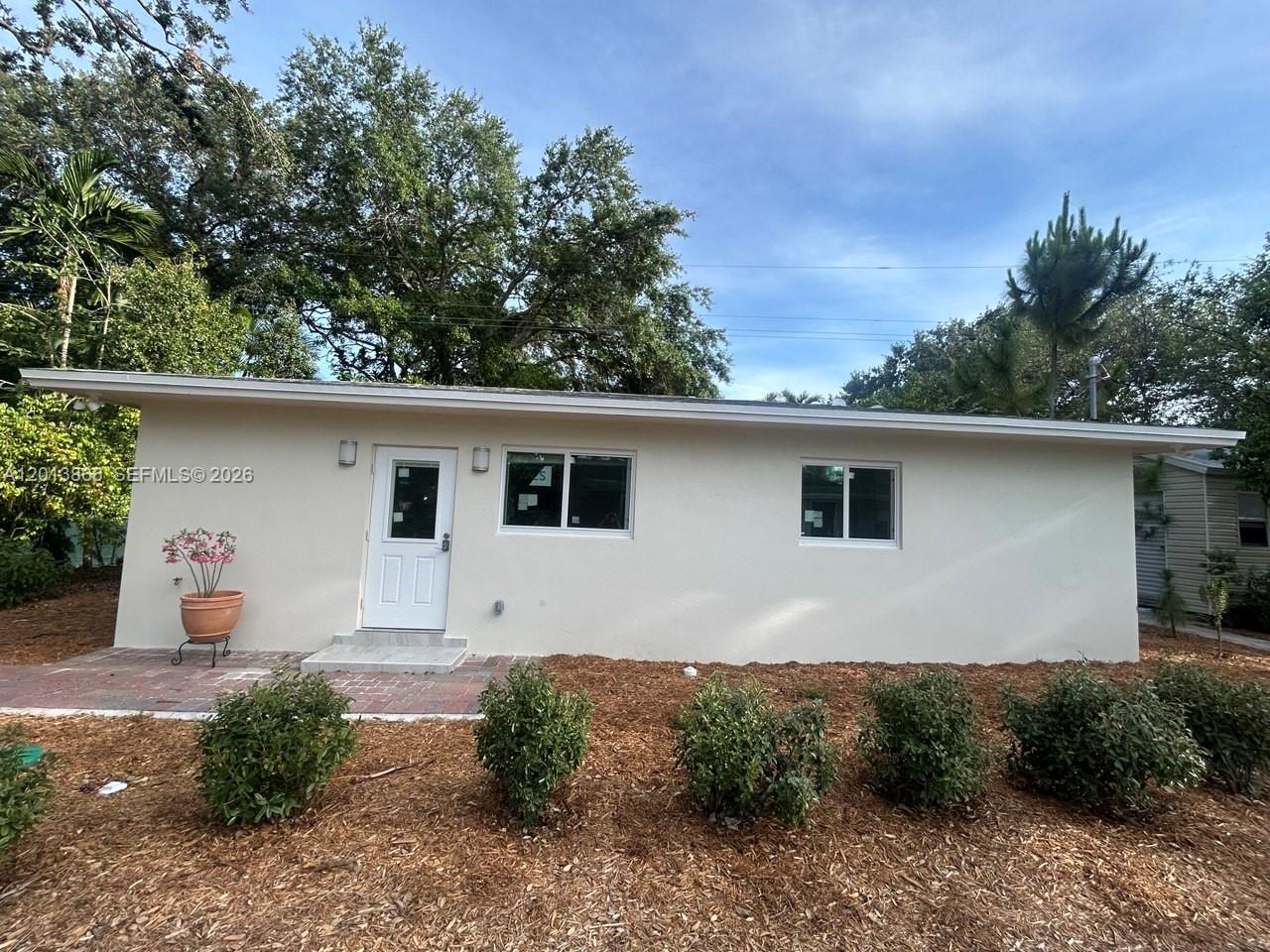 8440 Southwest 107th Street, Unit GH Miami, FL 33156 - Photo 21 of 22 a view of a house with a yard