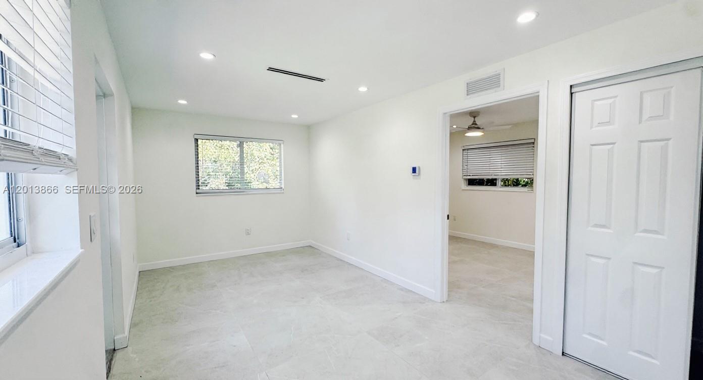 8440 Southwest 107th Street, Unit GH Miami, FL 33156 - Photo 3 of 22 an empty room with windows and closet