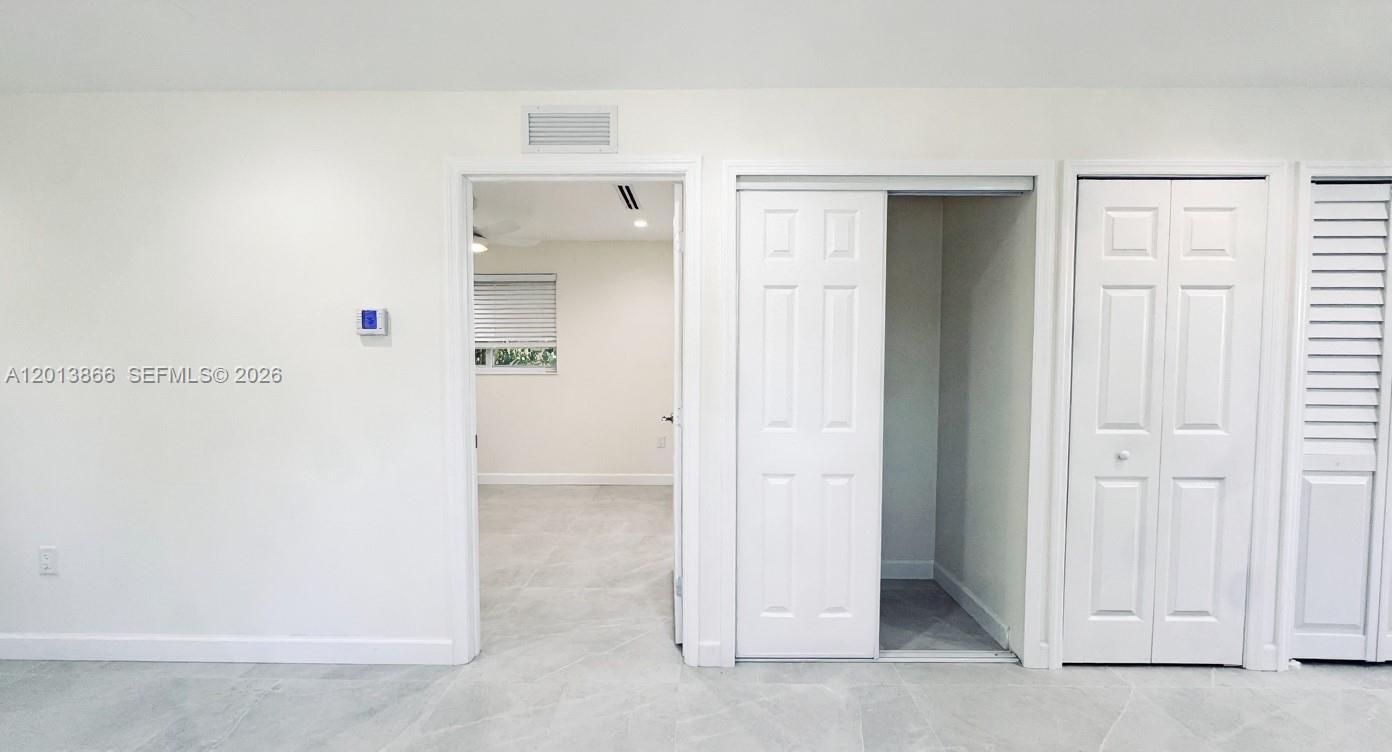 8440 Southwest 107th Street, Unit GH Miami, FL 33156 - Photo 6 of 22 a view of an empty room