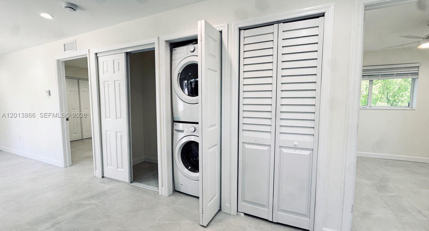 8440 Southwest 107th Street, Unit GH Miami, FL 33156 - Photo 7 of 22 a view of a kitchen with washer and dryer