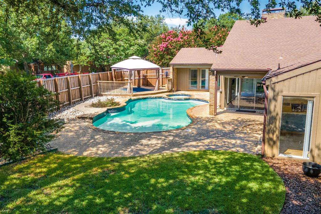 12902 Jennifer Place Dallas, TX 75243 - Photo 1 of 1 a front view of a house with a garden
