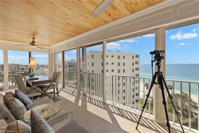 a living room with a large window and furniture