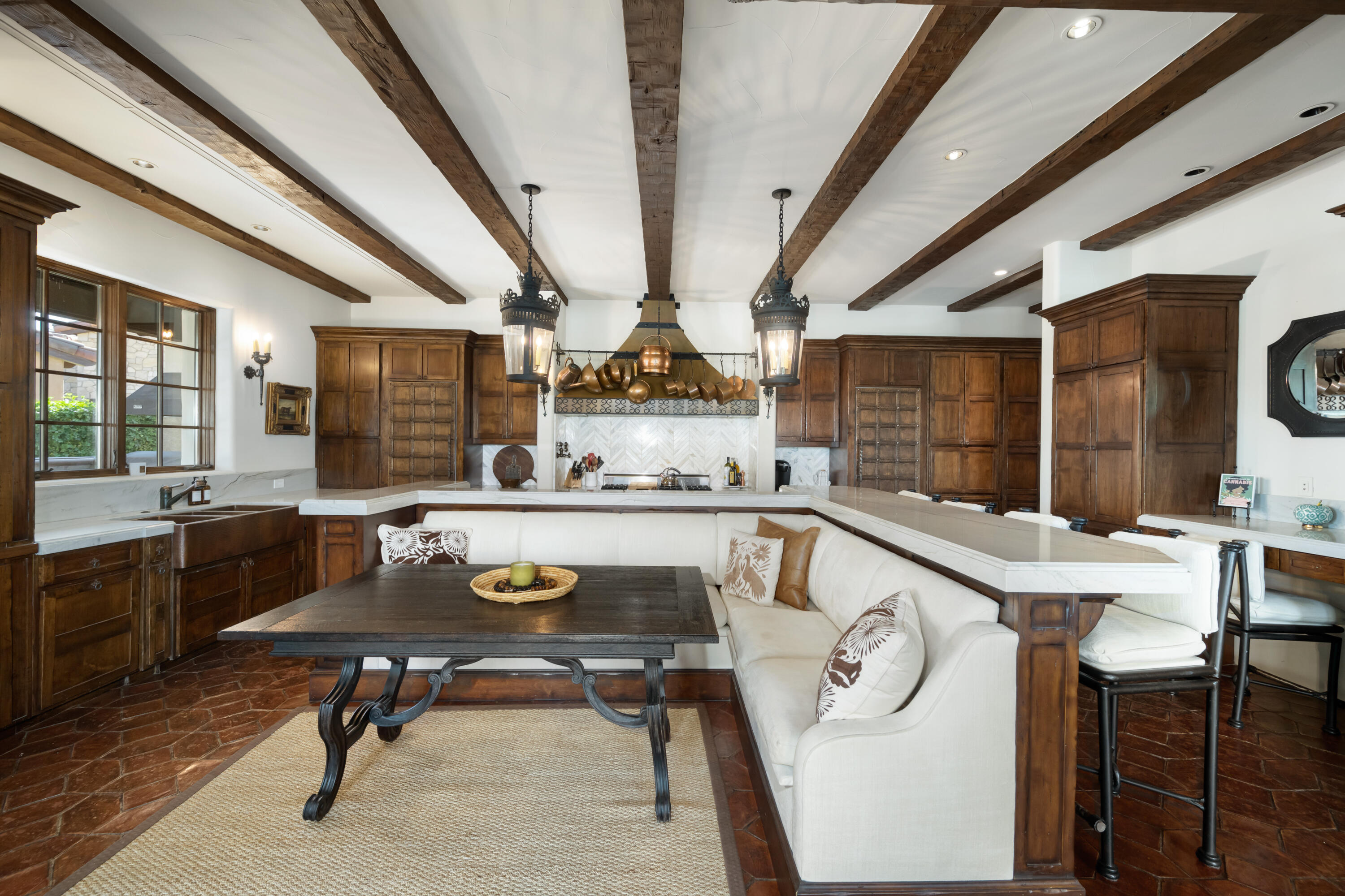 53760 Via Palacio La Quinta, CA 92253 - Photo 14 of 55 a view of a kitchen with kitchen island a stove a sink dishwasher a dining table and chairs with wooden floor
