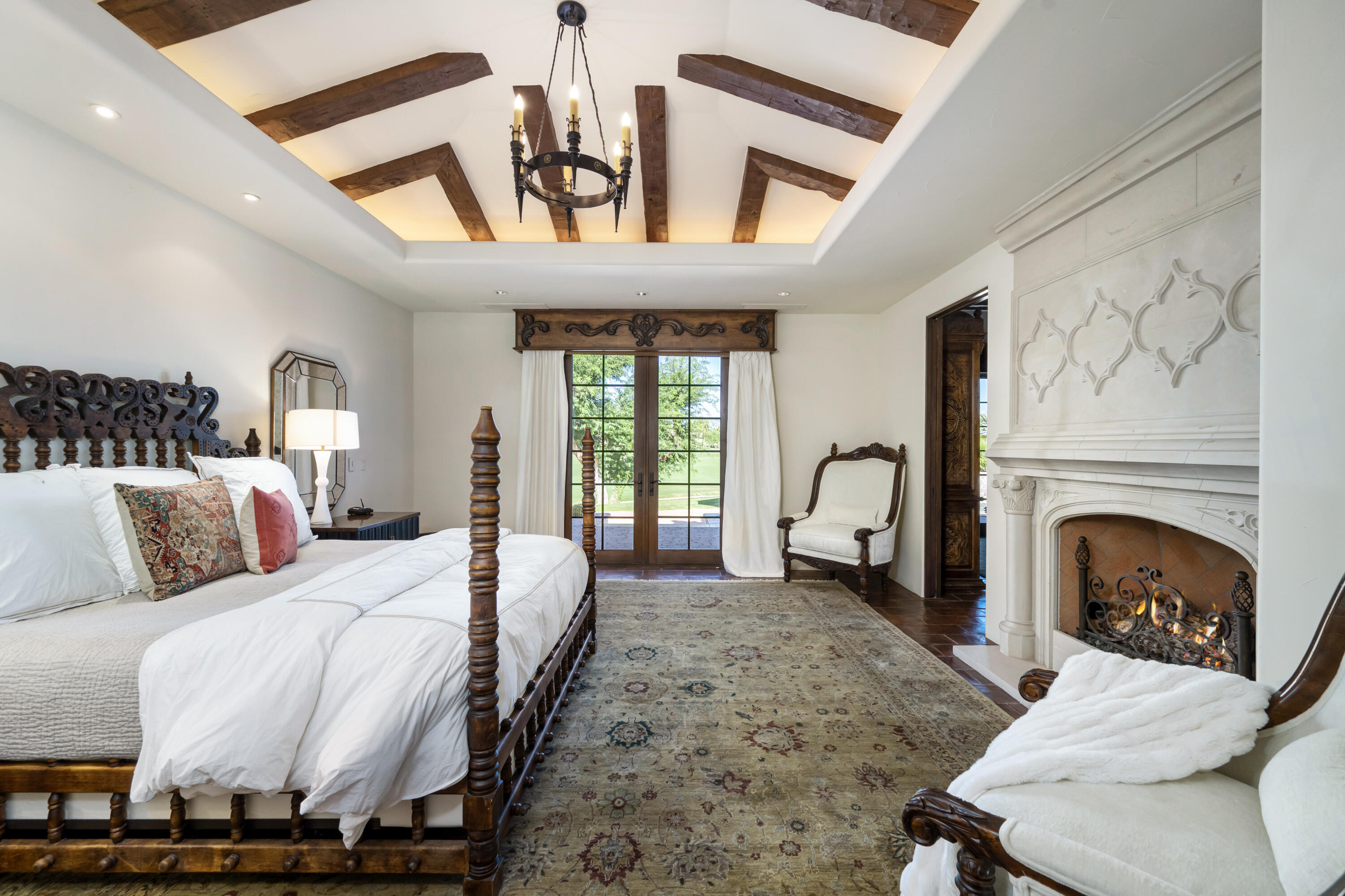 53760 Via Palacio La Quinta, CA 92253 - Photo 22 of 55 a large bedroom with a bed and a fireplace