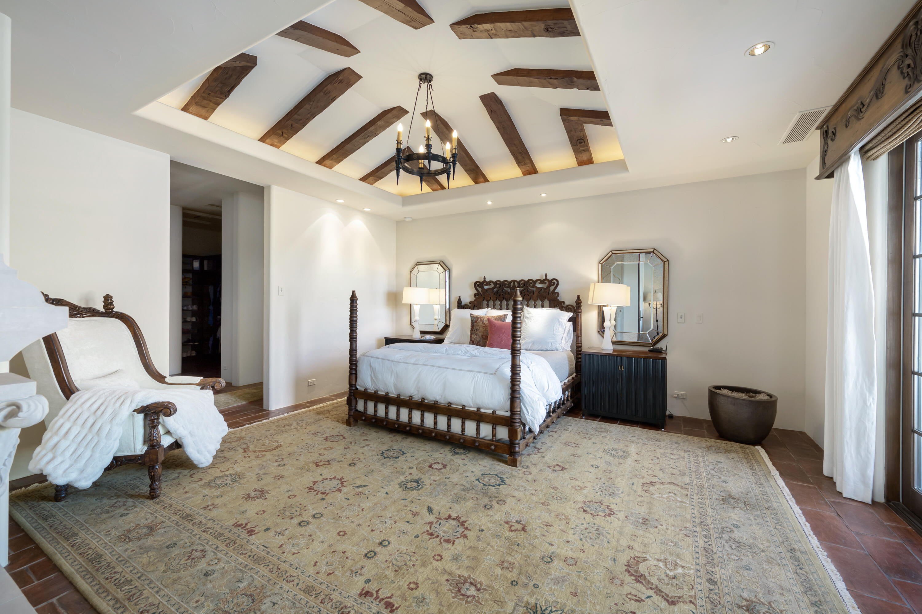 53760 Via Palacio La Quinta, CA 92253 - Photo 23 of 55 a bedroom with a bed a couch and chandelier