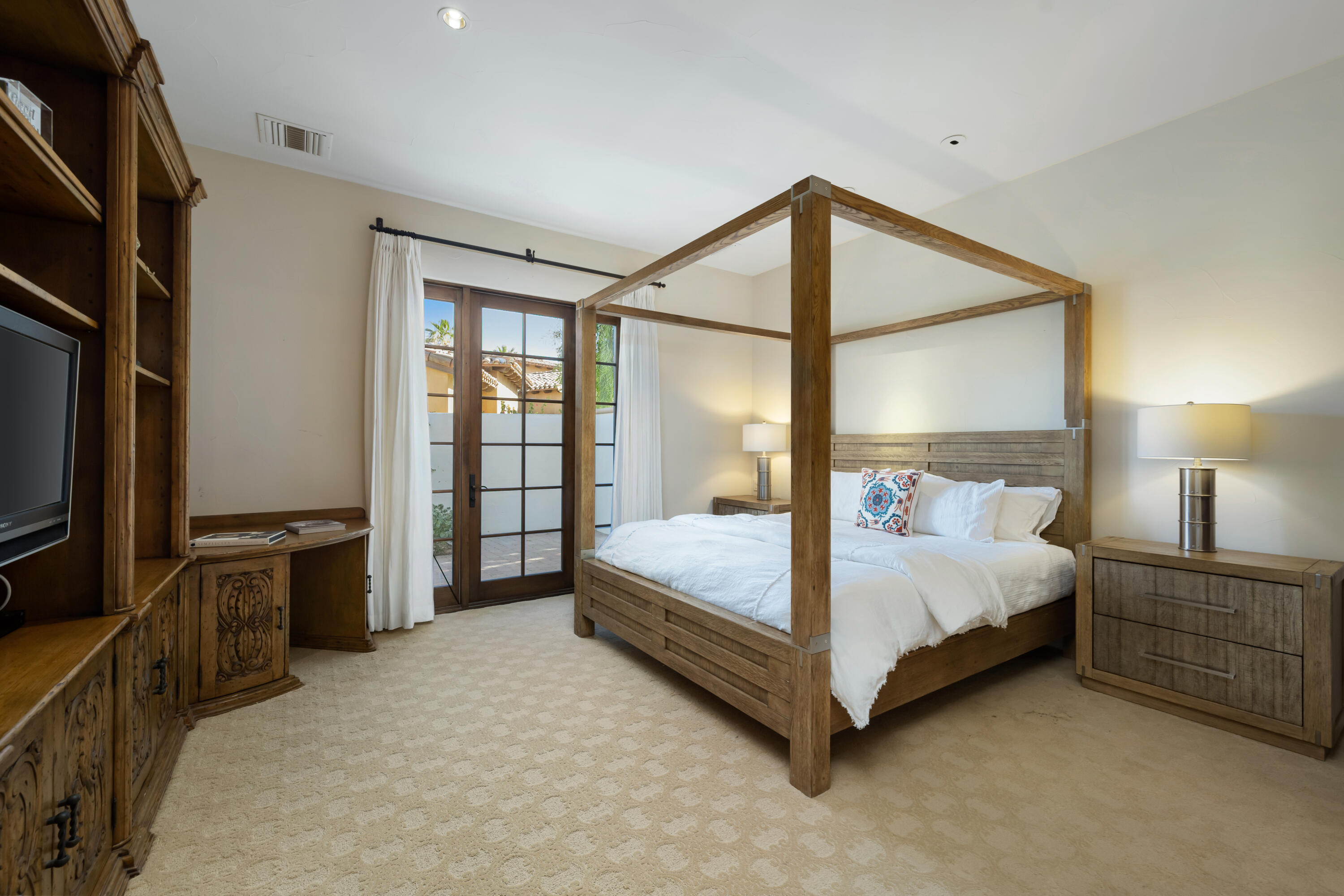 53760 Via Palacio La Quinta, CA 92253 - Photo 28 of 55 a bedroom with a bed and a flat tv screen on closet