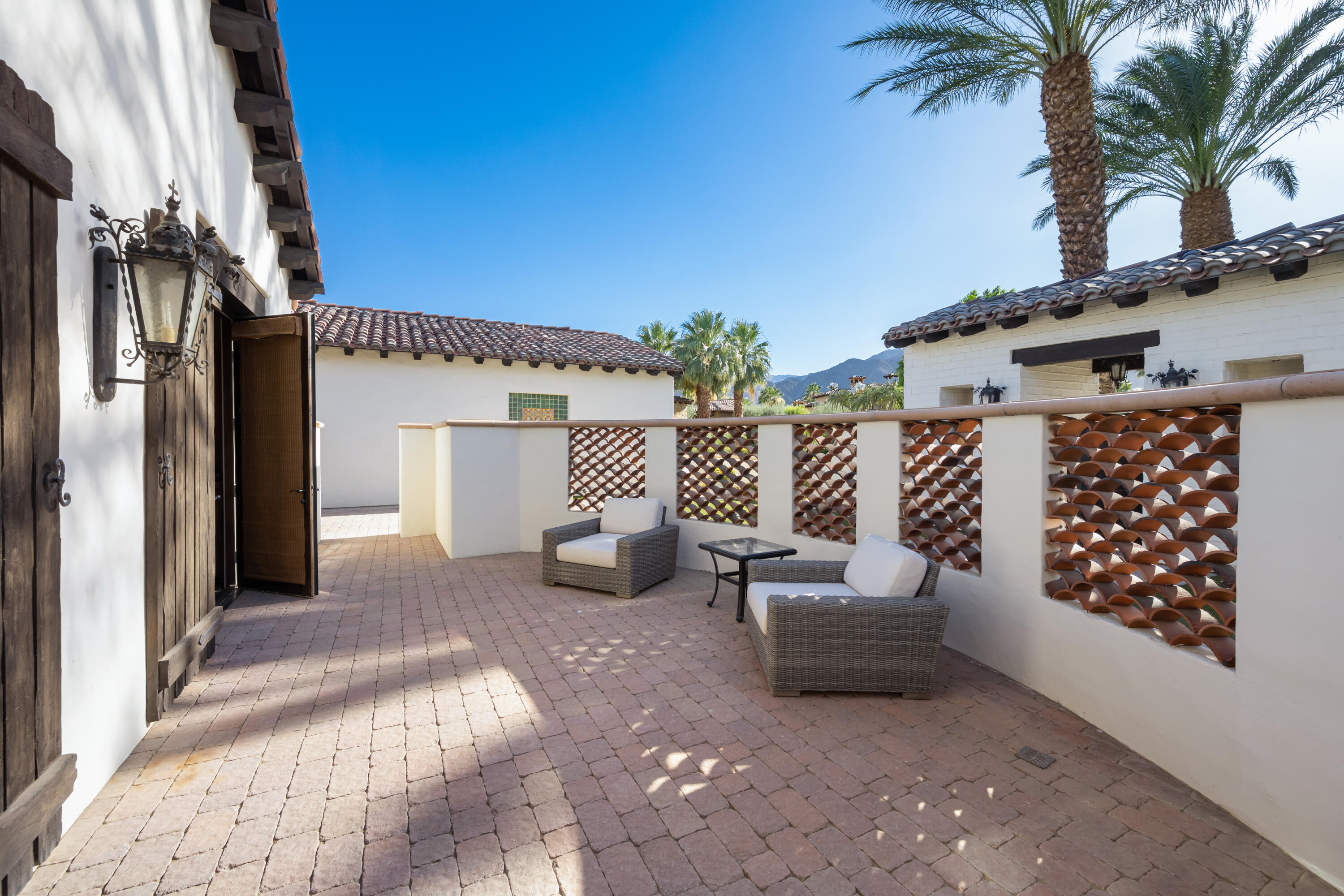 53760 Via Palacio La Quinta, CA 92253 - Photo 31 of 55 a view of a patio with couches and table and potted plants