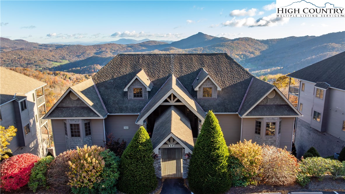 342 Ridgeline Drive, Unit 15B Sugar Mountain, NC 28604 - Photo 1 of 26 a front view of house with a garden