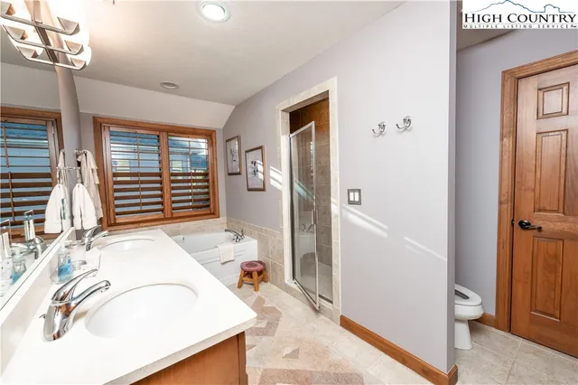 a bathroom with a sink a toilet and tub