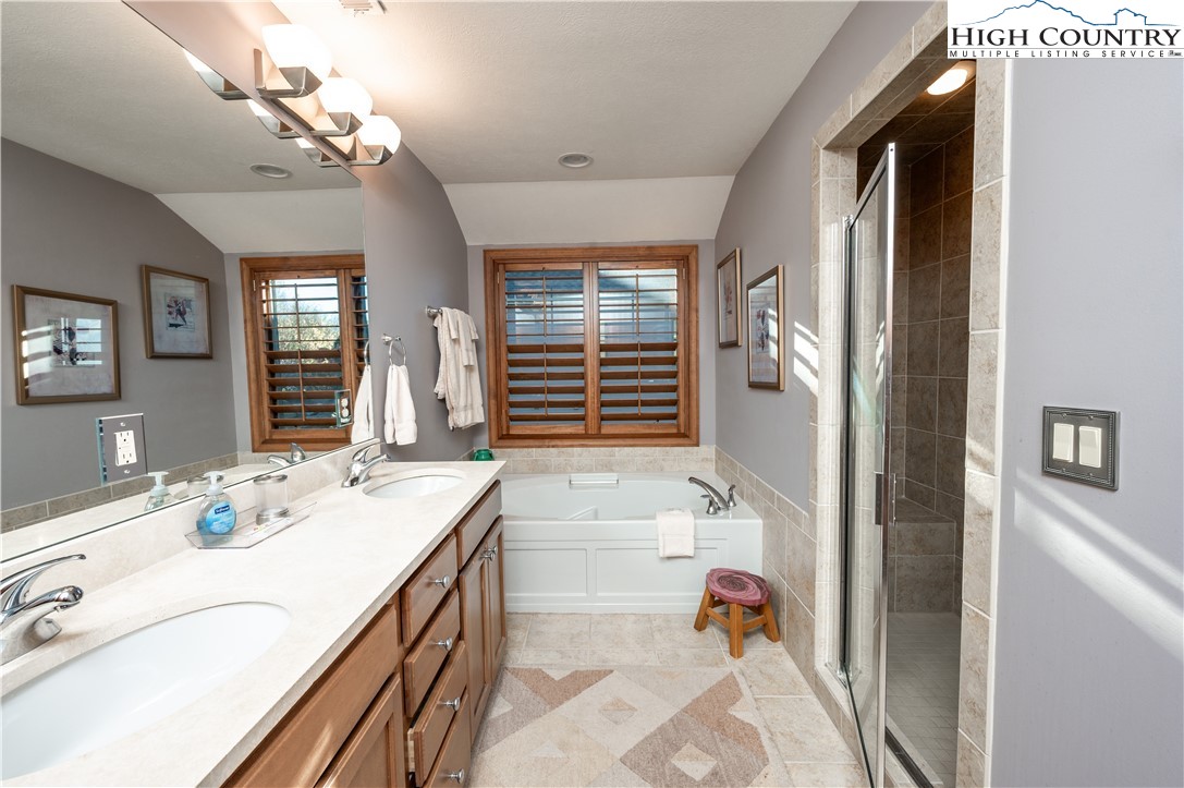342 Ridgeline Drive, Unit 15B Sugar Mountain, NC 28604 - Photo 12 of 26 a bathroom with a tub sink and a mirror