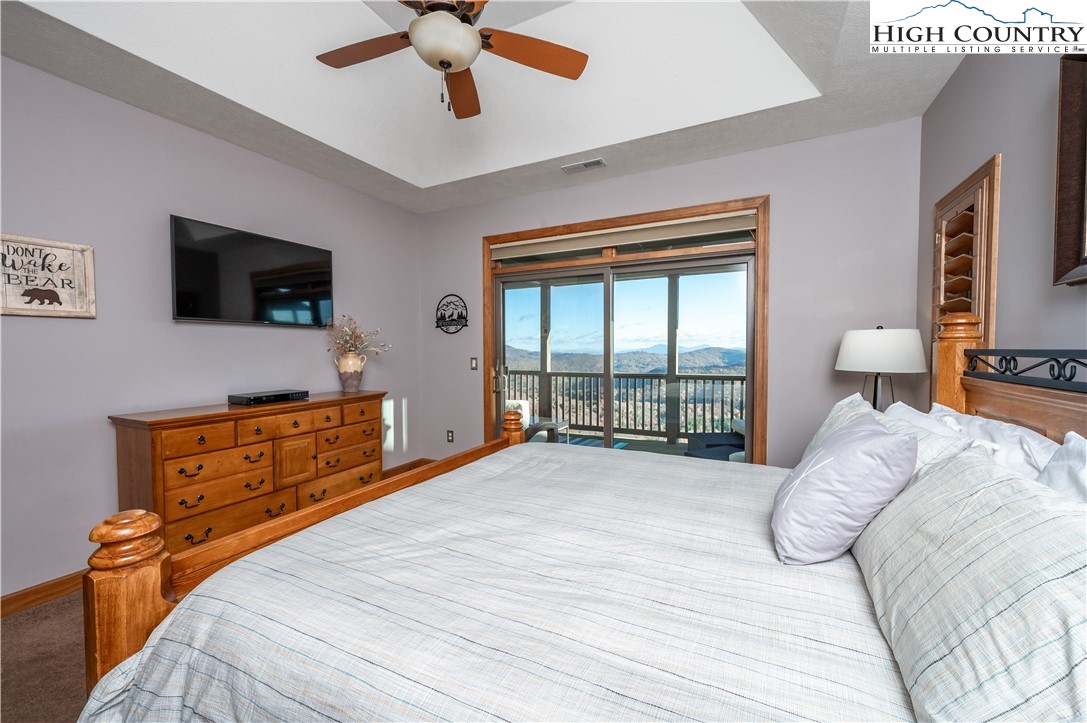 342 Ridgeline Drive, Unit 15B Sugar Mountain, NC 28604 - Photo 14 of 26 a bedroom with a bed and a flat tv screen on dresser