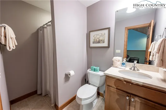 a bathroom with a sink toilet and a mirror