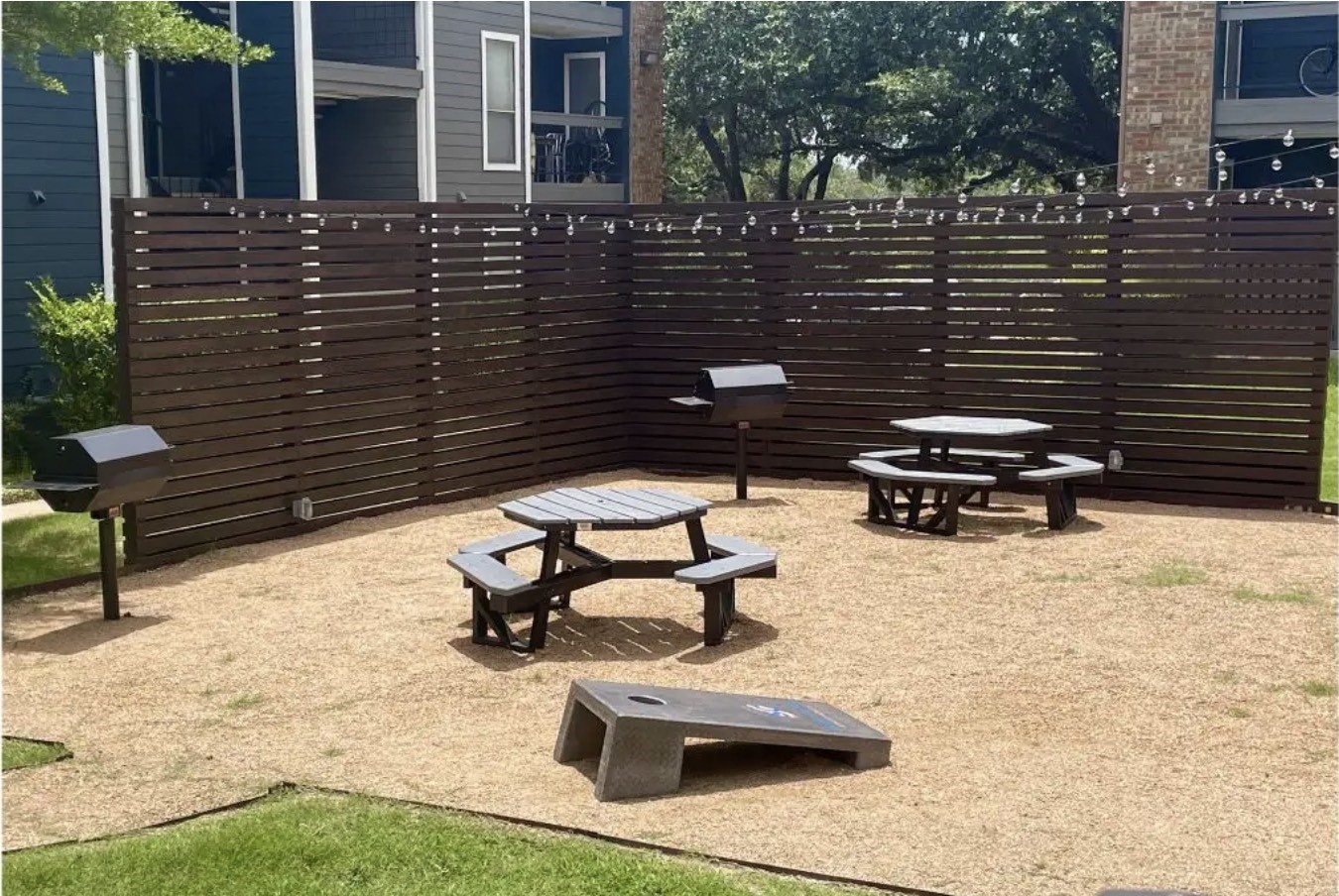 2170 Thousand Oaks Drive, Unit 536T San Antonio, TX 78232 - Photo 19 of 36 a view of a patio with table and chairs with wooden floor and fence